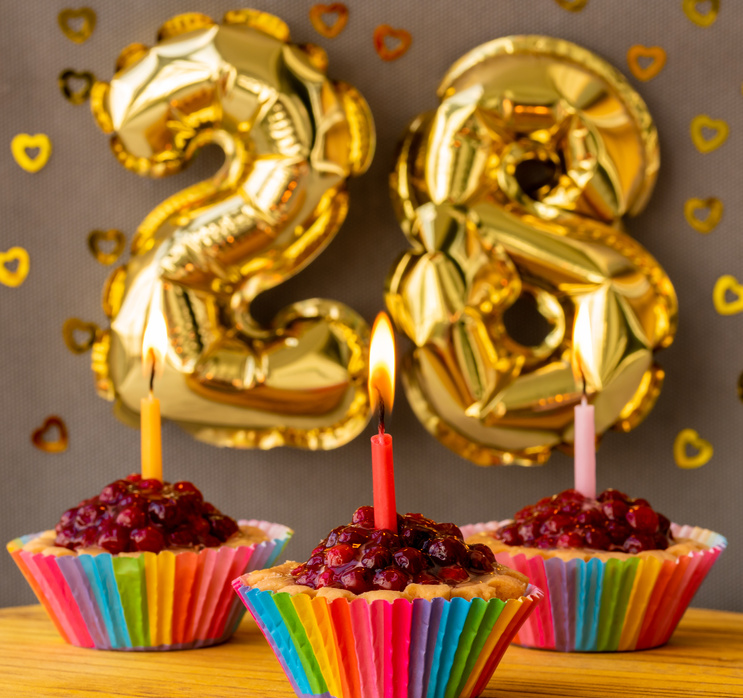 Three cakes-baskets with candles on the 28th birthday